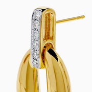 The 14K Yellow Gold Diamond Accented Sculptural Oval Drop Earrings feature vertical bars with sparkling diamond accents atop oval drops, shown against a white background.