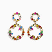 Watercolors 14K Gold Multi Sapphire and Diamond Dangle Bubble Earrings feature two linked open circles adorned with blue, green, yellow, pink, red, and clear sapphires plus diamonds for an eye-catching pop of color.