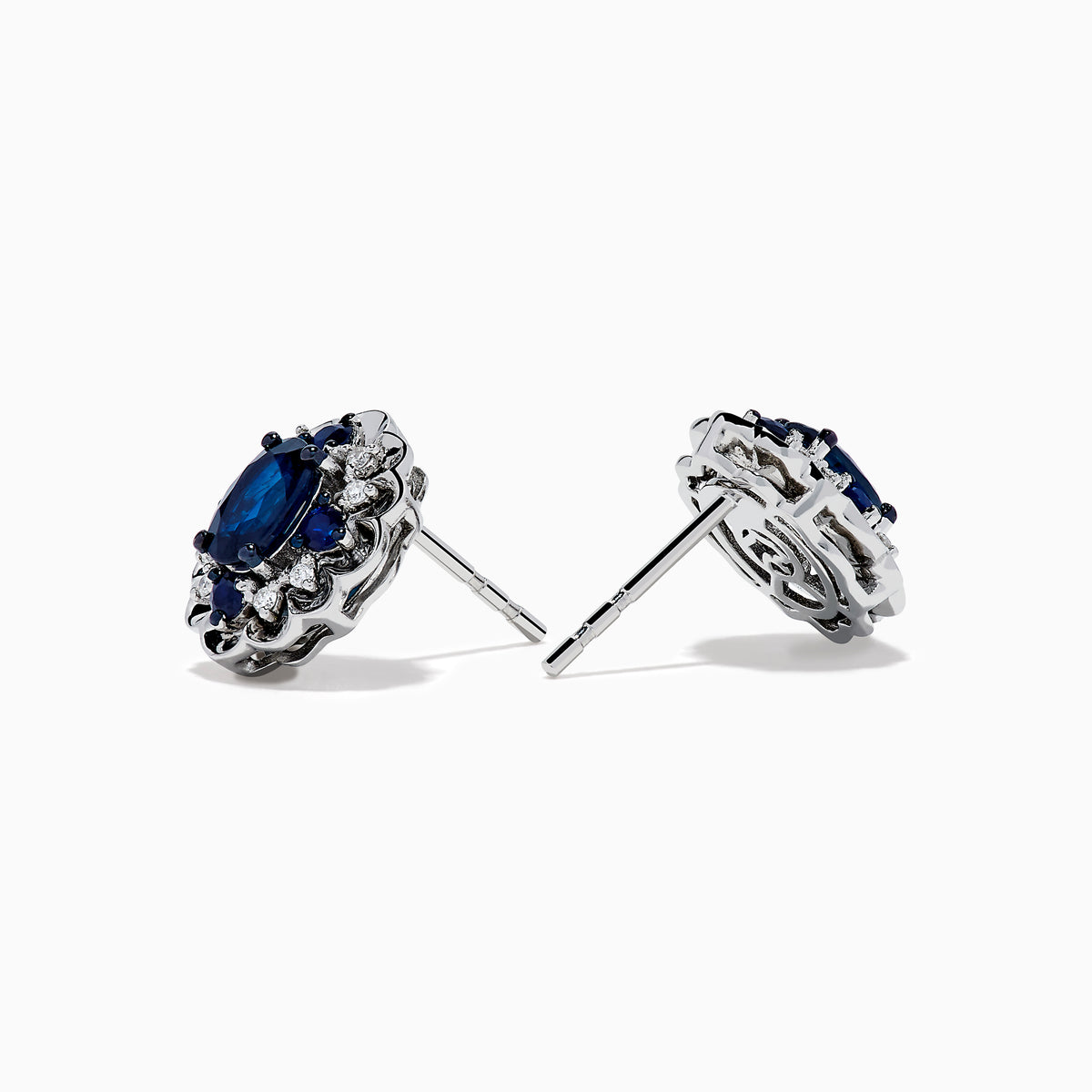 14K White Gold Sapphire and Diamond Vintage Halo Stud Earrings with oval blue sapphires surrounded by a halo of diamonds, shown on a white background.
