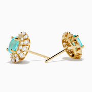 A pair of 18K Yellow Gold Paraiba and Diamond Stud Earrings featuring an oval Paraiba gemstone at the center, surrounded by a halo of small clear diamonds, displayed on a white background.