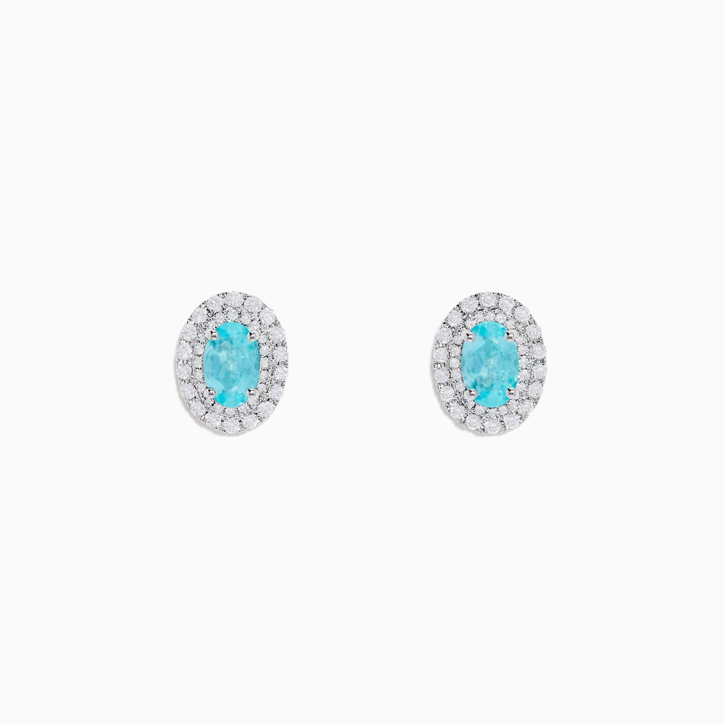18K White Gold Paraiba and Diamond Stud Earrings featuring oval blue Paraiba center stones, each encircled by a halo of sparkling diamonds, set against a white background.