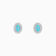 18K White Gold Paraiba and Diamond Stud Earrings featuring oval blue Paraiba center stones, each encircled by a halo of sparkling diamonds, set against a white background.