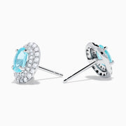 18K White Gold Paraiba and Diamond Stud Earrings featuring oval blue Paraiba center stones, each encircled by a halo of sparkling diamonds, set against a white background.