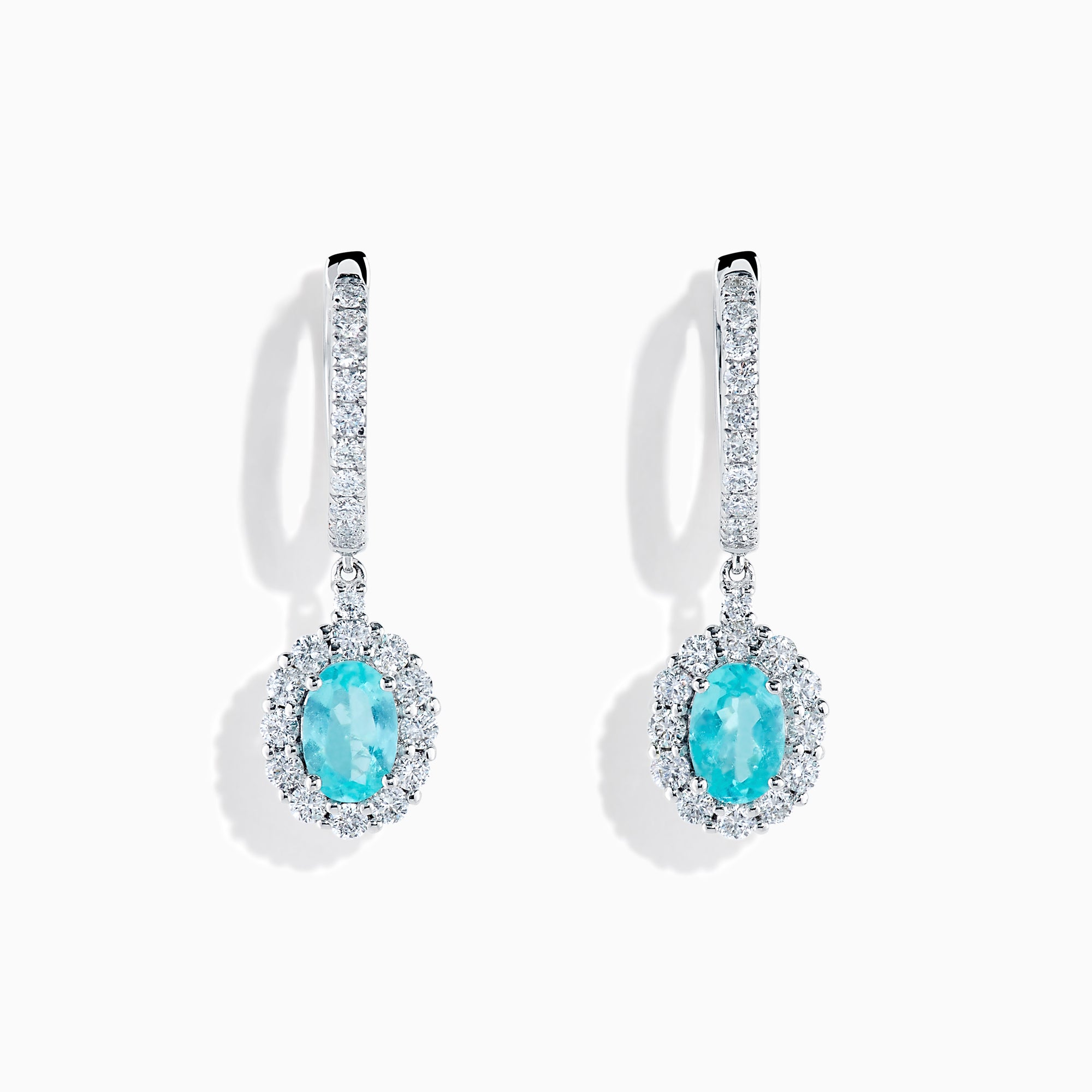A pair of elegant 18K White Gold Paraiba and Diamond Oval Halo Drop Earrings, featuring vibrant oval Paraiba stones encircled by sparkling diamonds and additional gems on the hooks, displayed on a white background.