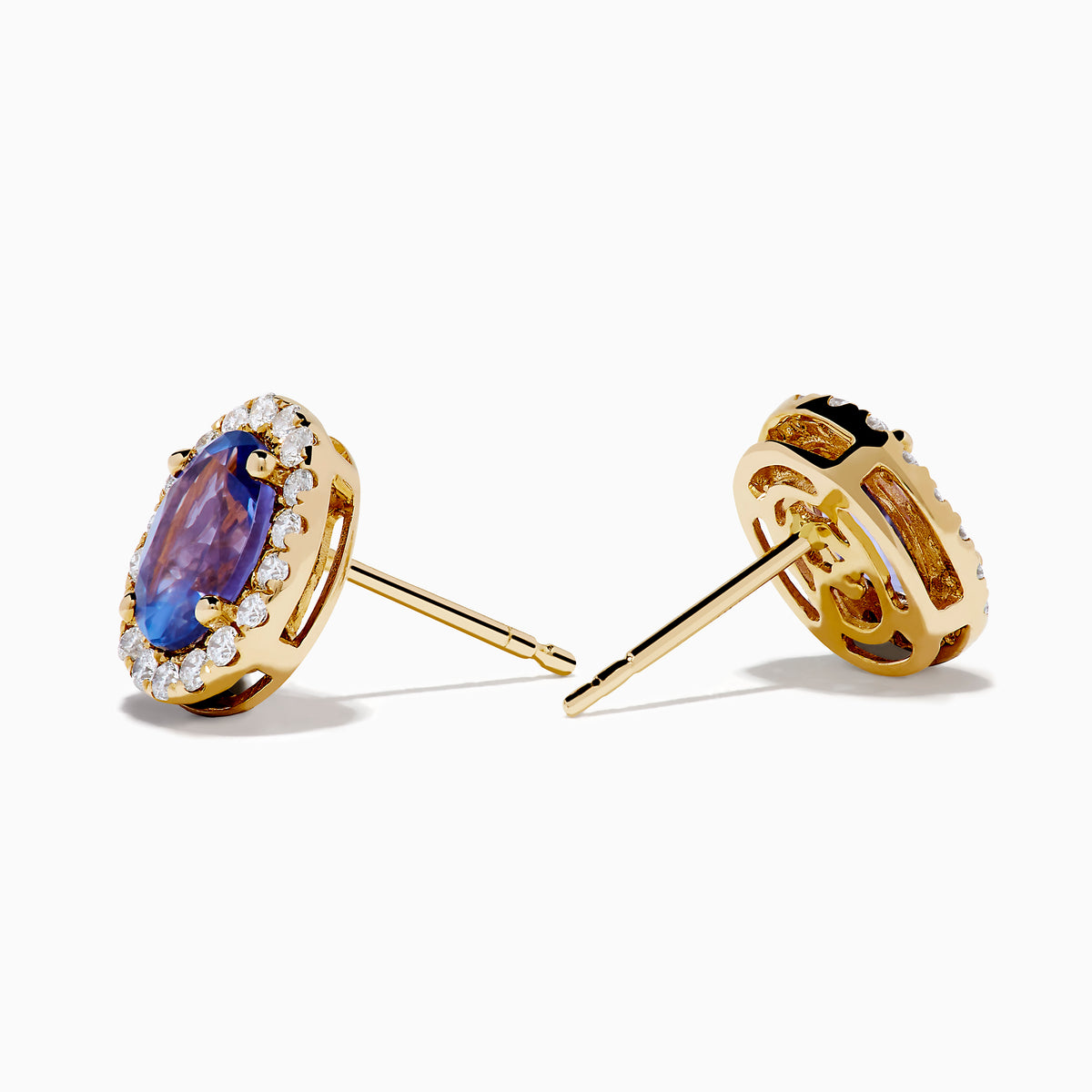 The Nahla 14K Yellow Gold Tanzanite and Diamond Stud Earrings feature oval blue tanzanites haloed by small diamonds, set in yellow gold and shown on a white background.