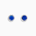 The Nahla Siri 14K White Gold Tanzanite and Diamond Stud Earrings feature vivid blue tanzanite centers surrounded by sparkling diamonds in a classic round stud design.