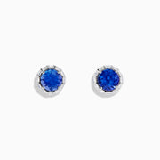The Nahla Siri 14K White Gold Tanzanite and Diamond Stud Earrings feature vivid blue tanzanite centers surrounded by sparkling diamonds in a classic round stud design.