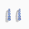 Nahla Siri Sterling Silver Tanzanite Hoop Earrings, each adorned with five round tanzanite stones set vertically on sterling silver, are displayed against a white background.