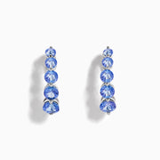 Nahla Siri Sterling Silver Tanzanite Hoop Earrings, each adorned with five round tanzanite stones set vertically on sterling silver, are displayed against a white background.