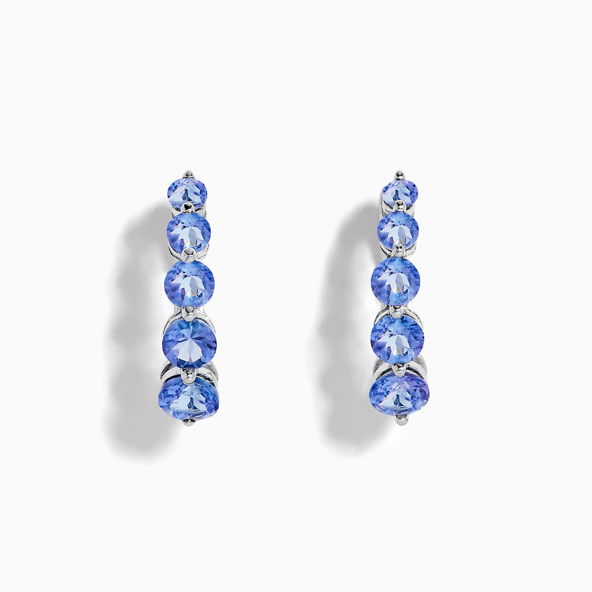 Nahla Siri Sterling Silver Tanzanite Hoop Earrings, each adorned with five round tanzanite stones set vertically on sterling silver, are displayed against a white background.