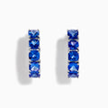 Nahla Siri Sterling Silver 7/8 Hoop Earrings, each featuring five cushion-cut tanzanite stones, displayed on a white background.