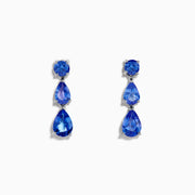 The Nahla Siri 925 Silver Tanzanite Drop Earrings feature three blue gemstones—one round and two teardrop-shaped—in varying blue shades, set against a white background.