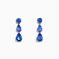 The Nahla Siri 925 Silver Tanzanite Drop Earrings feature three blue gemstones—one round and two teardrop-shaped—in varying blue shades, set against a white background.