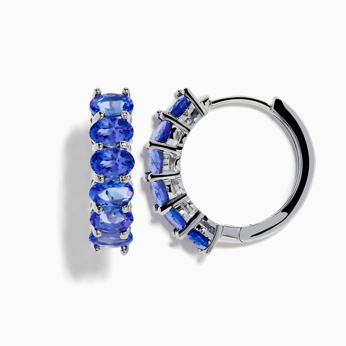 The Nahla Siri 925 Silver Tanzanite Hoop Earrings feature five oval tanzanite gemstones in prong settings, elegantly crafted from sterling silver and showcased against a plain white background.