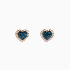 The Bella Bleu 14K Rose Gold Blue and White Diamond Heart Earrings showcase blue and white diamonds at the center, bordered by clear stones in a rose gold setting, displayed against a white background.
