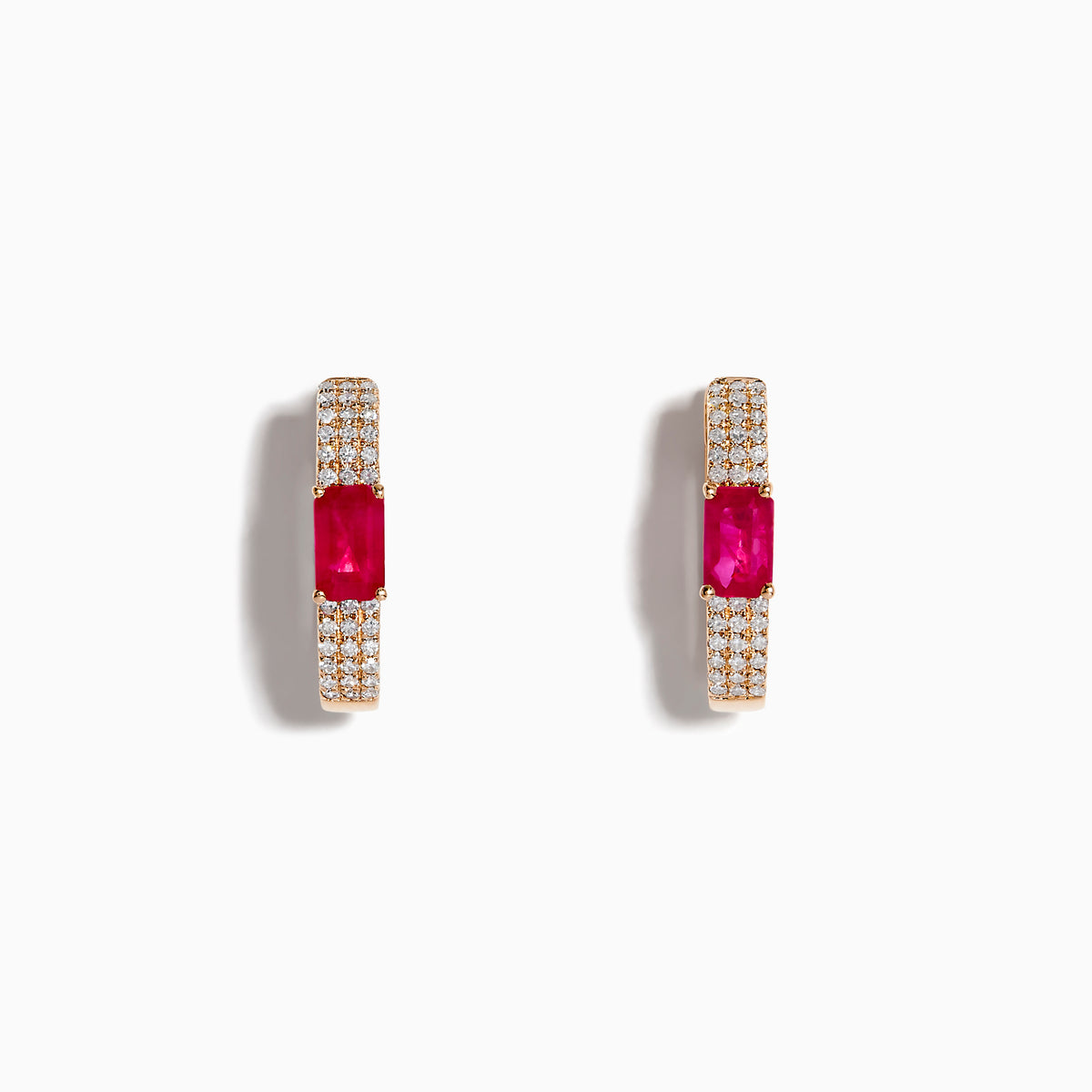 The Ruby Royale 14K Rose Gold Ruby and Diamond Huggie Earrings feature rectangular red rubies flanked by rows of sparkling white diamonds, set in rose gold and displayed against a white background.