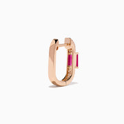 The Ruby Royale 14K Rose Gold Ruby and Diamond Huggie Earrings feature rectangular red rubies flanked by rows of sparkling white diamonds, set in rose gold and displayed against a white background.