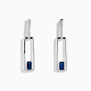 The Royale Bleu 14K White Gold Sapphire and Diamond Drop Earrings feature rectangular hoops adorned with diamonds and a central blue sapphire at the bottom of each elegant earring.