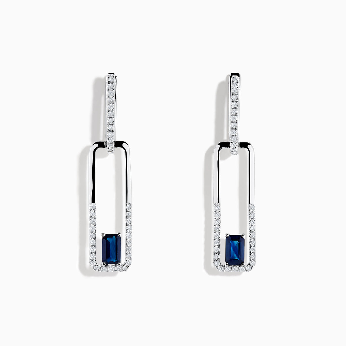 The Royale Bleu 14K White Gold Sapphire and Diamond Drop Earrings feature rectangular hoops adorned with diamonds and a central blue sapphire at the bottom of each elegant earring.