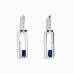 The Royale Bleu 14K White Gold Sapphire and Diamond Drop Earrings feature rectangular hoops adorned with diamonds and a central blue sapphire at the bottom of each elegant earring.