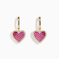 Novelty 14K yellow gold heart earrings with ruby, pink sapphire, and diamond accents are elegantly displayed on a white background.
