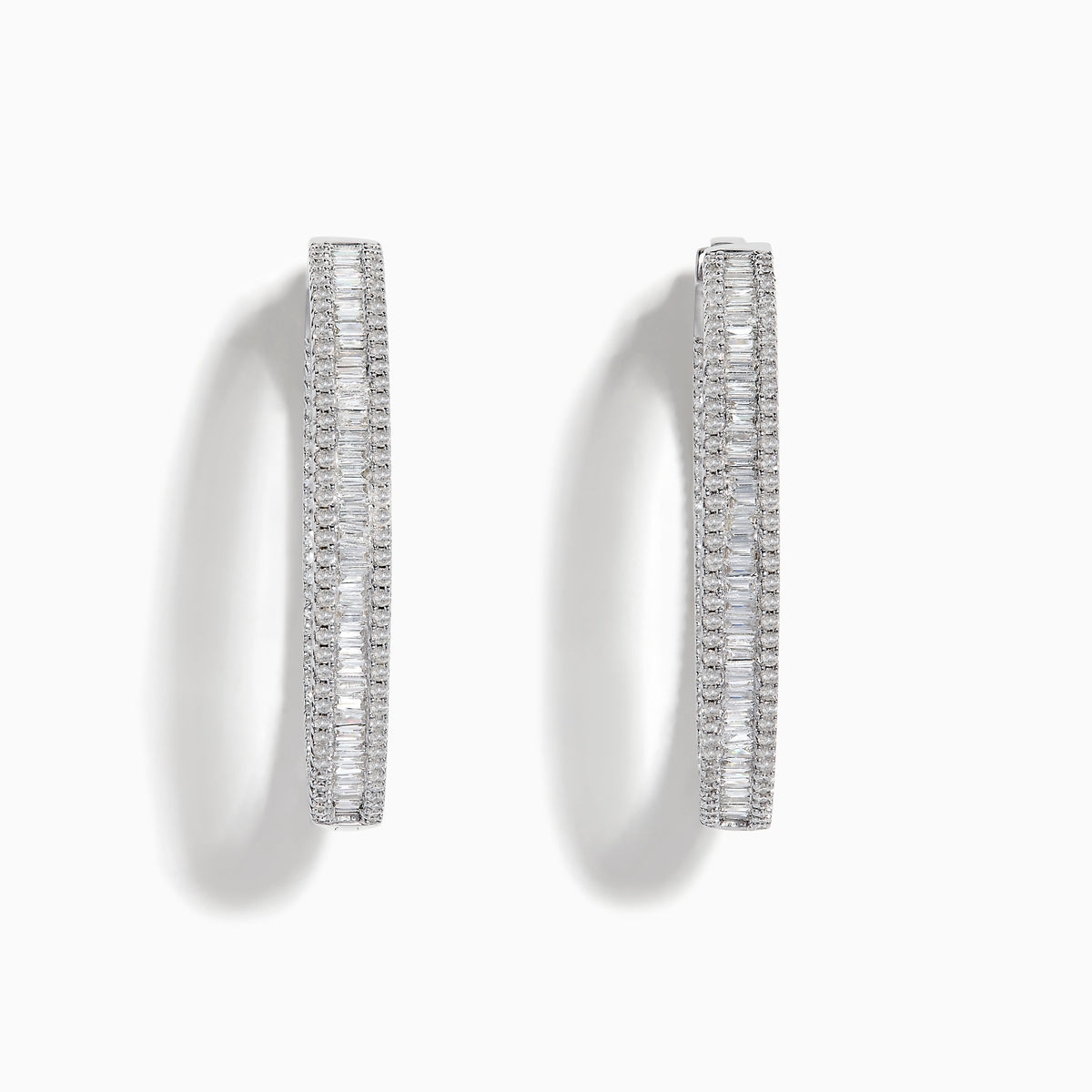 The Pave Classica 14 Karat White Gold Diamond 1.25 Hoop Earrings feature sparkling white diamonds totaling 2.24 TCW, set in elegant oval-shaped hoops and shown against a plain white background.
