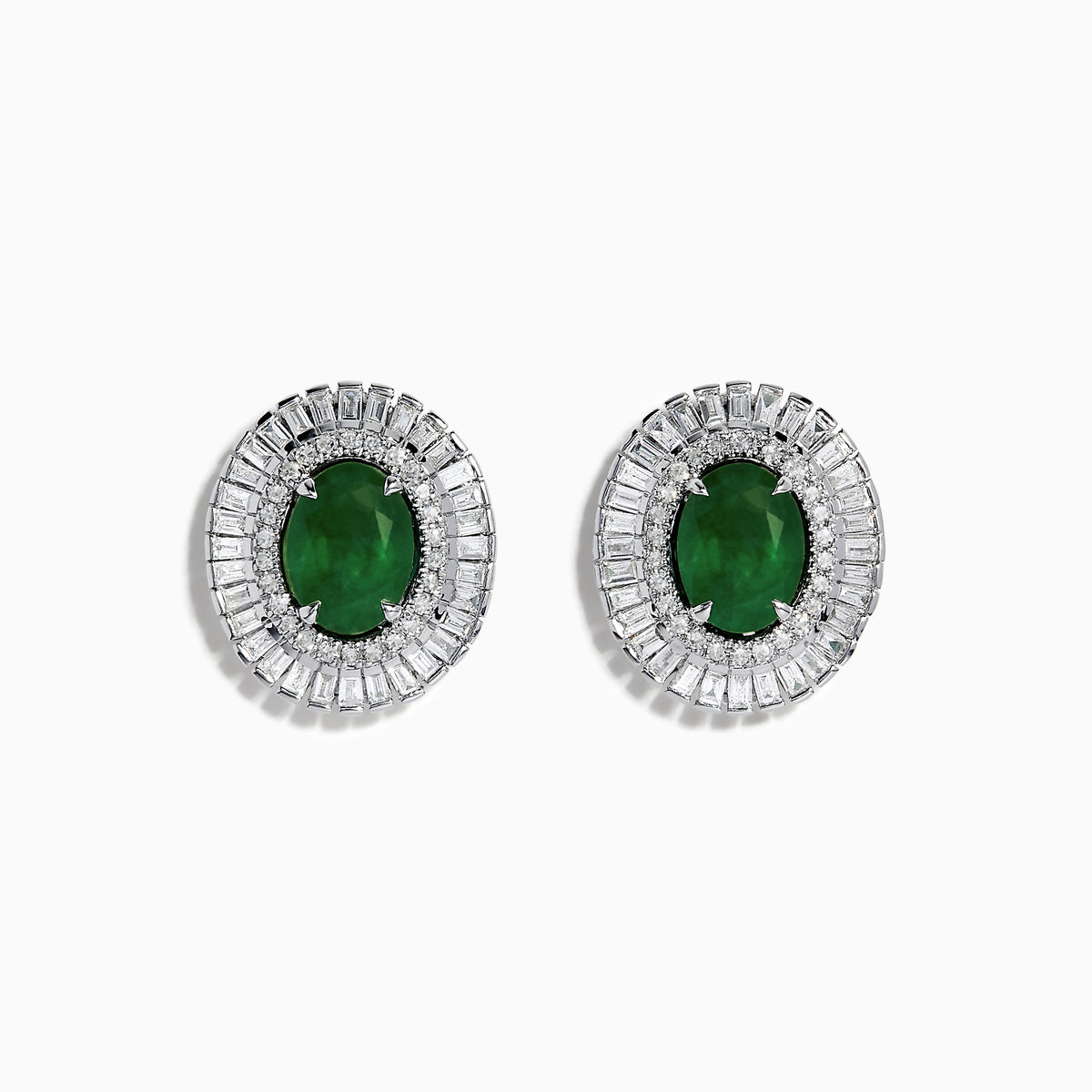 These 14K White Gold Emerald and Diamond Stud Earrings feature large oval emeralds at the center, accented by clear rectangular-cut diamonds for an elegant look.