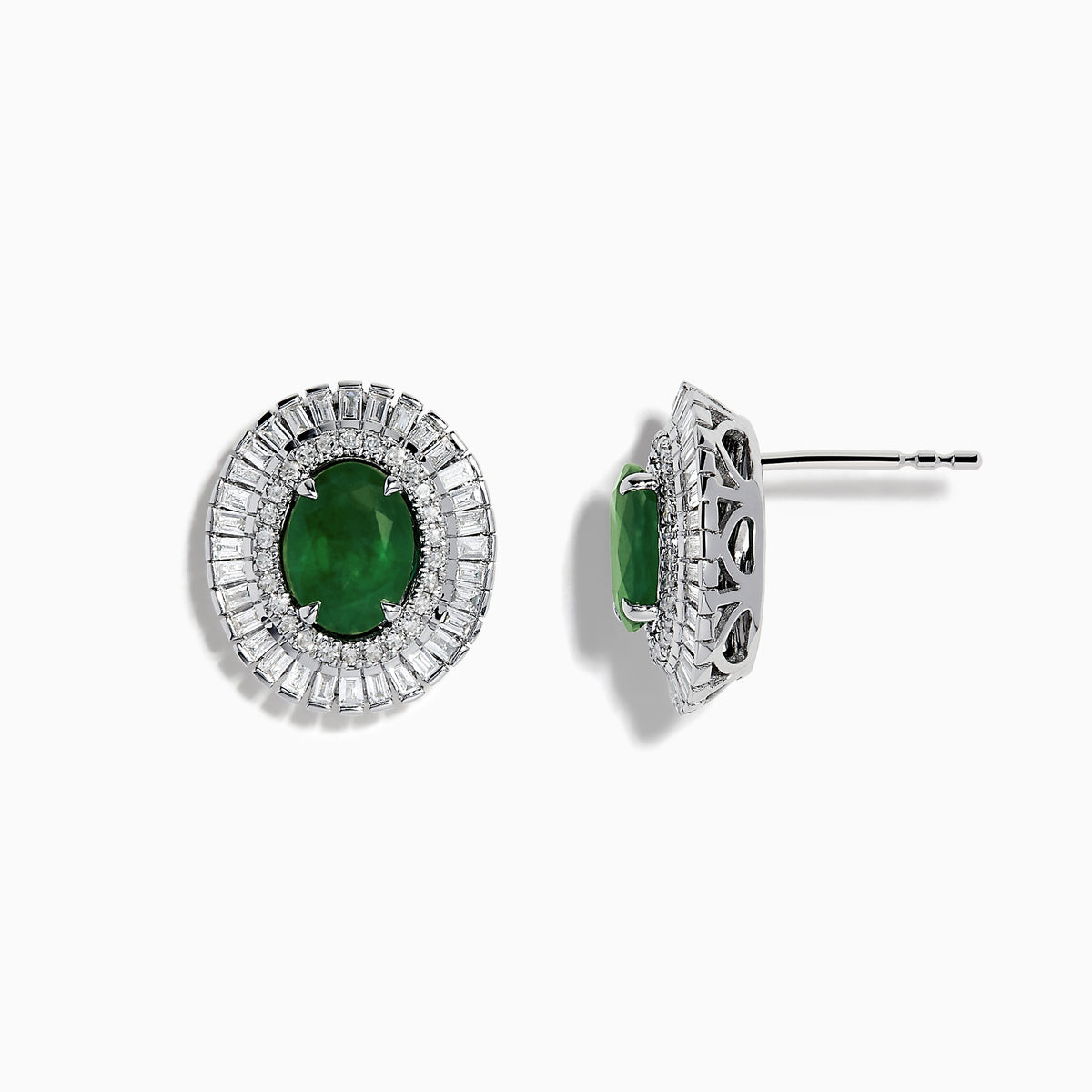 These 14K White Gold Emerald and Diamond Stud Earrings feature large oval emeralds at the center, accented by clear rectangular-cut diamonds for an elegant look.