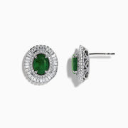These 14K White Gold Emerald and Diamond Stud Earrings feature large oval emeralds at the center, accented by clear rectangular-cut diamonds for an elegant look.