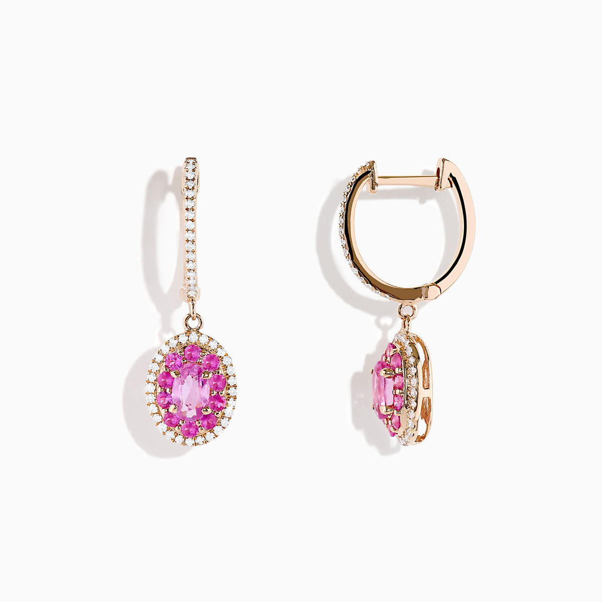 The 14K Rose Gold Pink Sapphire and Diamond Earrings feature oval pink sapphires encircled by diamonds, each suspended from a diamond-studded hook, displayed on a white background.
