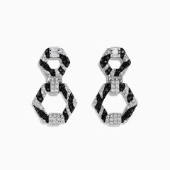 Showcased on a white background, these 14k White Gold Black and White Diamond Zebra Print Earrings feature alternating black and silver hexagonal segments encrusted with sparkling stones.