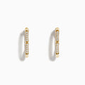 The DOro 14 Karat Yellow Gold 5/8 Diamond Bamboo Hoop Earrings, featuring sparkling diamonds in a bamboo-inspired design, are displayed on a plain white background.