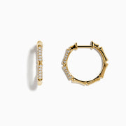 The DOro 14 Karat Yellow Gold 5/8 Diamond Bamboo Hoop Earrings, featuring sparkling diamonds in a bamboo-inspired design, are displayed on a plain white background.