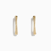 The DOro 14K Yellow Gold Diamond Hoop Earrings feature a subtle curve and sparkling diamonds along the front edge, beautifully showcased against a plain white background.