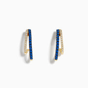 The Royal Bleu 14K Yellow Gold Sapphire and Diamond Double Hoop Earrings feature a zigzag design with sparkling sapphires and white stones, shown against a white background.