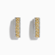 The 14K Two Tone White and Yellow Diamond Hoop Earrings feature a central row of yellow diamonds bordered by small white diamonds in a rectangular design, set in stunning silver or white gold, displayed on a white background.