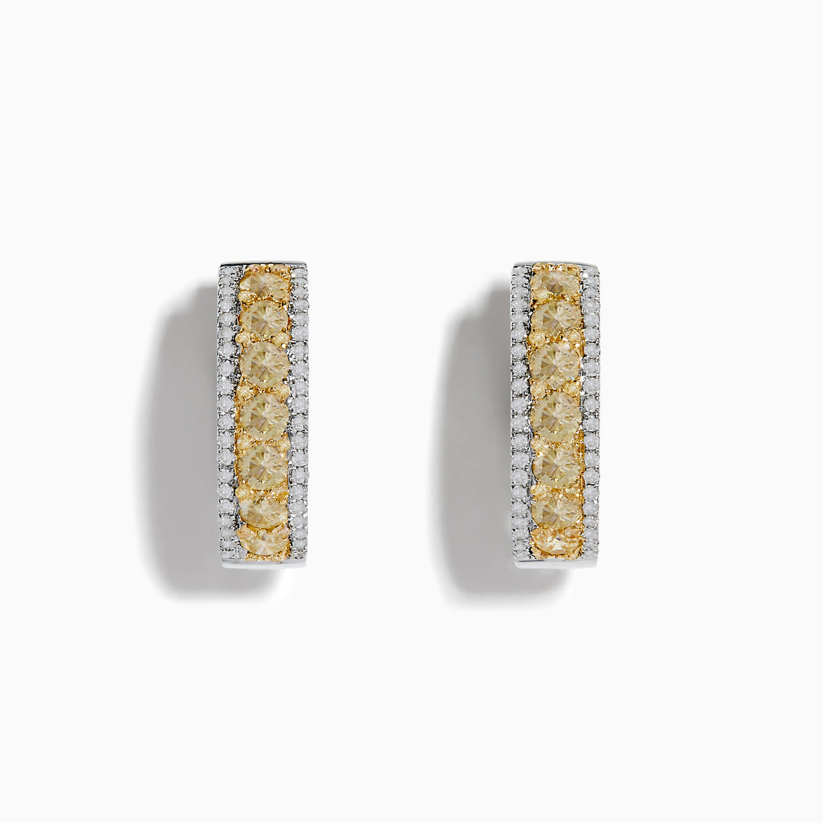 The 14K Two Tone White and Yellow Diamond Hoop Earrings feature a central row of yellow diamonds bordered by small white diamonds in a rectangular design, set in stunning silver or white gold, displayed on a white background.