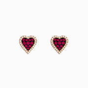 14K Rose Gold Ruby and Diamond Heart Earrings featuring red rubies at the center, bordered by small diamonds, displayed on a white background.