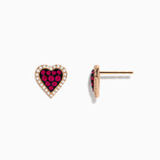 14K Rose Gold Ruby and Diamond Heart Earrings featuring red rubies at the center, bordered by small diamonds, displayed on a white background.