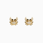 Seaside 14K Yellow Gold White & Black Diamond Crab Earrings, featuring sparkling bodies and striking black eyes, are shaped like crabs and displayed on a white background.