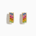 The Watercolors 14K Yellow Gold Multi Sapphire and Diamond Mini Hoop Earrings feature vibrant rows of colorful sapphires bordered by sparkling diamonds, shown against a white background.