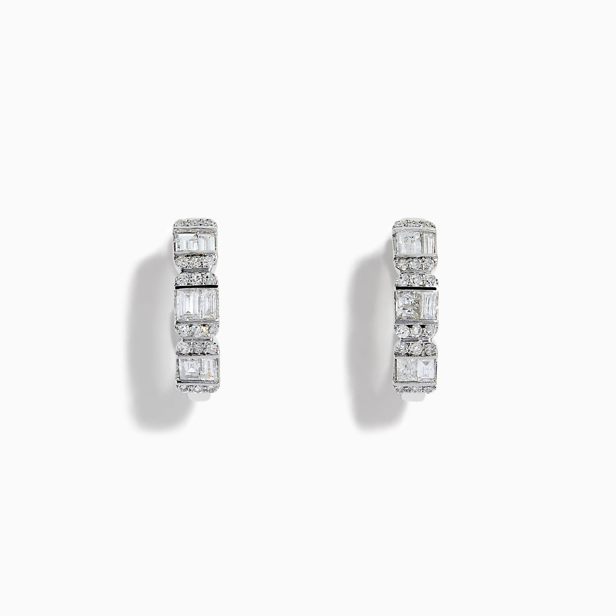 A pair of Classique 14K White Gold Diamond Hoop Earrings, featuring rectangular and round clear gemstones, shown on a white background with soft shadows to the left of each earring.