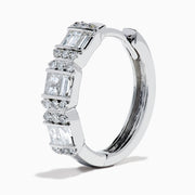 A pair of Classique 14K White Gold Diamond Hoop Earrings, featuring rectangular and round clear gemstones, shown on a white background with soft shadows to the left of each earring.