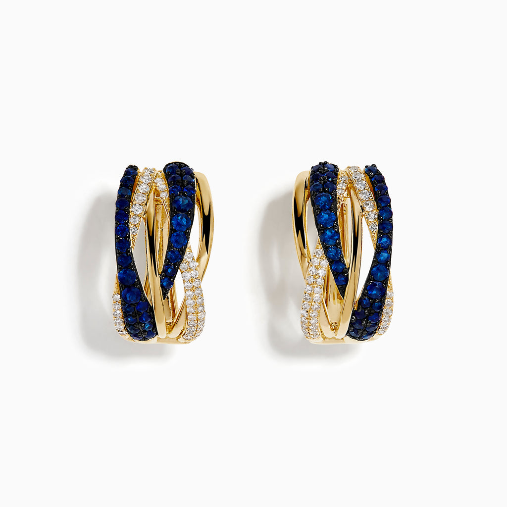 The 14K Yellow Gold Sapphire and Diamond Crossover Hoop Earrings feature intertwined bands set with blue sapphires and small clear diamonds, shown against a white background.