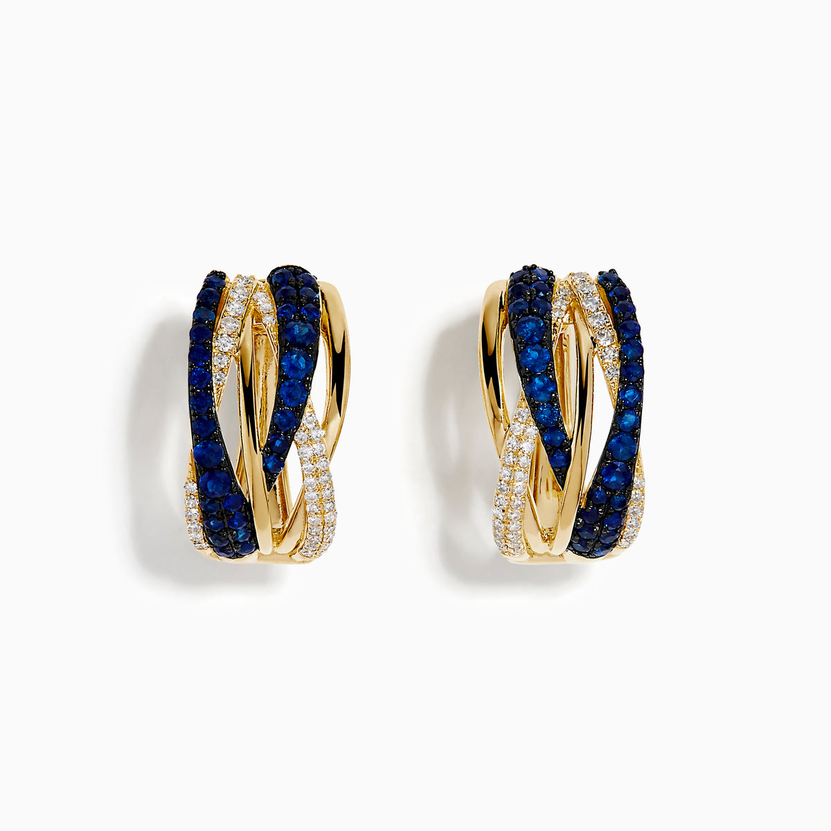 The 14K Yellow Gold Sapphire and Diamond Crossover Hoop Earrings feature intertwined bands set with blue sapphires and small clear diamonds, shown against a white background.