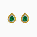 These 14K two tone gold emerald double halo earrings feature white and yellow diamonds in a teardrop design, elegantly displayed against a plain white background.