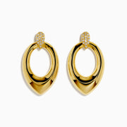 The 14K Yellow Gold Sculptural Diamond Accented Drop Earrings feature a teardrop outline and diamond accents at the top where they attach to the ear.
