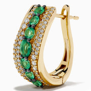 The 14K Yellow Gold Emerald and Diamond Hoop Earrings feature two rows of white diamonds, a central row of oval green gemstones, and a wavy design—ideal for fans of elegant emerald hoops.