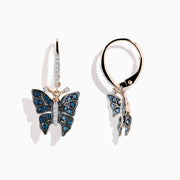 The 14K Rose Gold White and Blue Diamond Butterfly Earrings feature delicate butterfly designs with blue and white diamond accents on rose gold hooks, set against a white background.