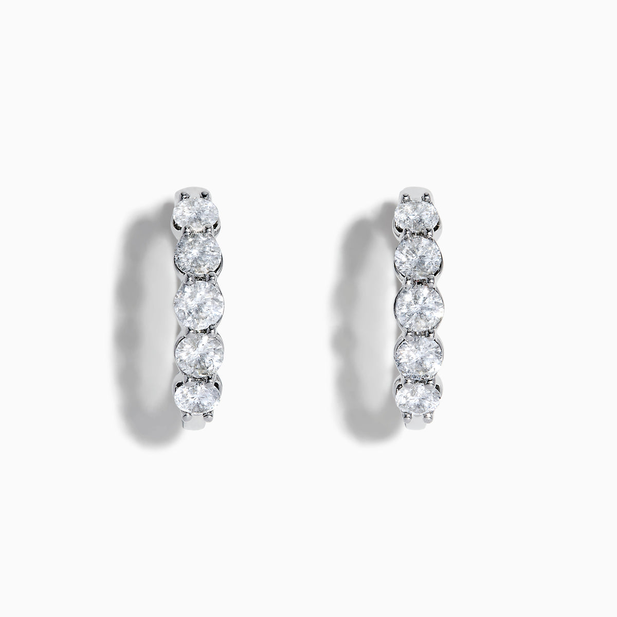 The Classique 14K White Gold Diamond Hoop Earrings feature five round diamonds on each hoop, shown against a white background for a timeless look.